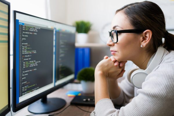 Computer programmer examining code